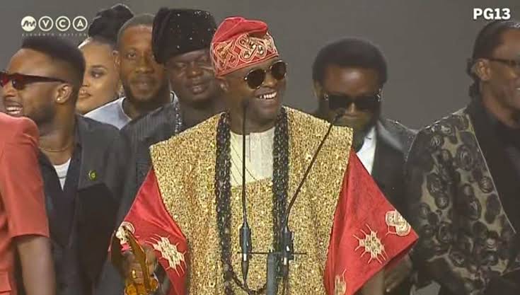 Femi Adebayo receiving award for best actor on stage at AMVCA 2025